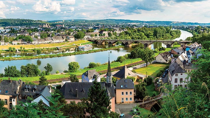 The Moselle river flowing through the town of Trier during the summer, Germany